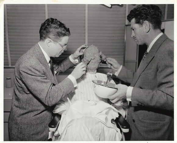 MGM MAKE-UP DEPARTMENT | WILLIAM TUTTLE, JACK YOUNG MAKE LIFE MASK (ca. 1943) Publicity photo