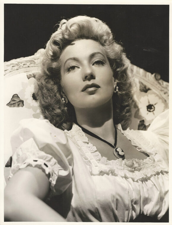 ANN SOTHERN WEARS CAMEO AND PEASANT BLOUSE (1942) Oversized photo